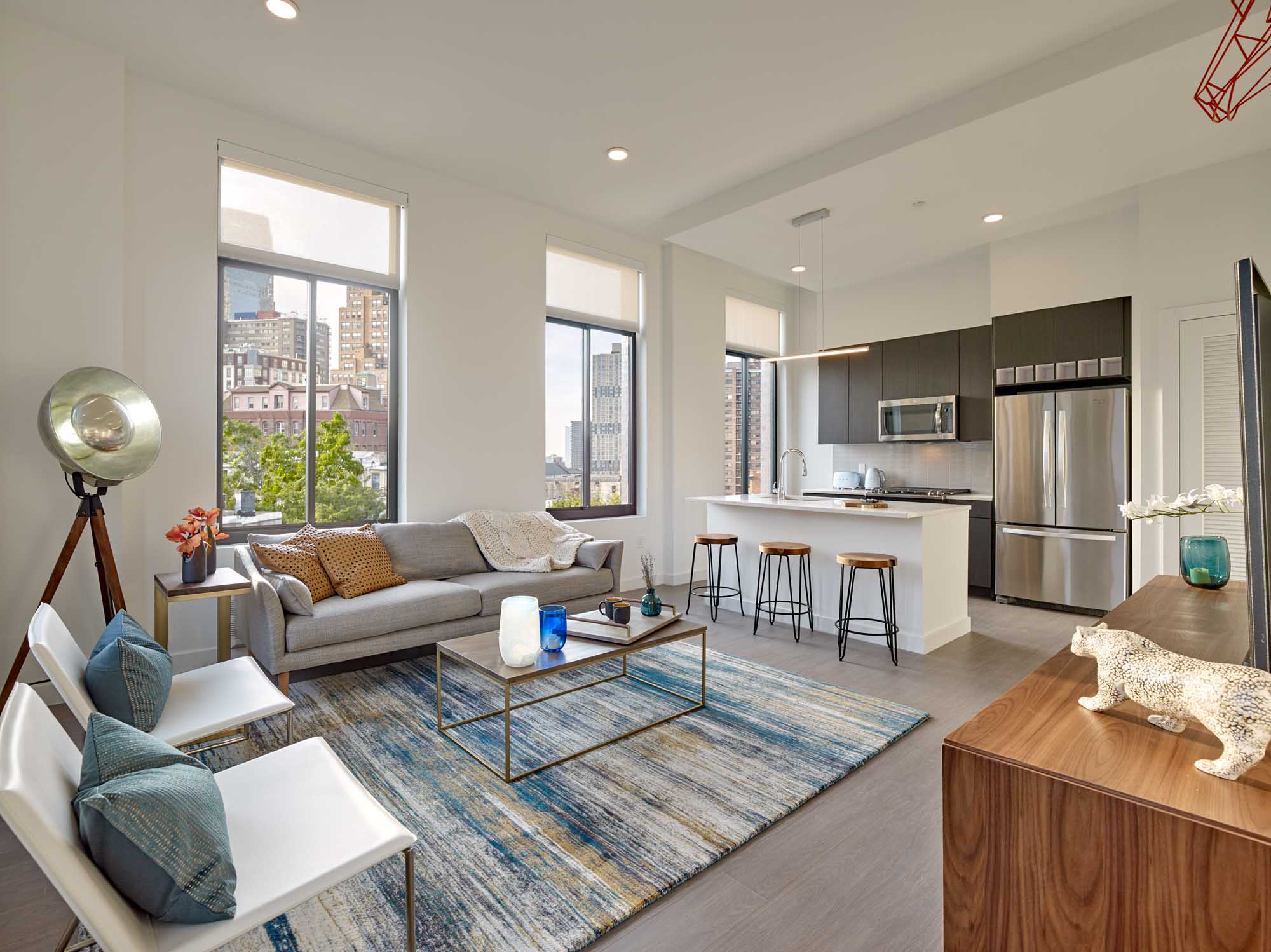 Modern City Apartment with Open Layout, Living room with bar seating leads to kitchen.
